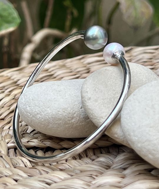 Une perle d’eau douce blanche et une perle de Tahiti. Ensemble, elles incarnent l’équilibre subtil de deux univers — la profondeur mystérieuse du lagon.