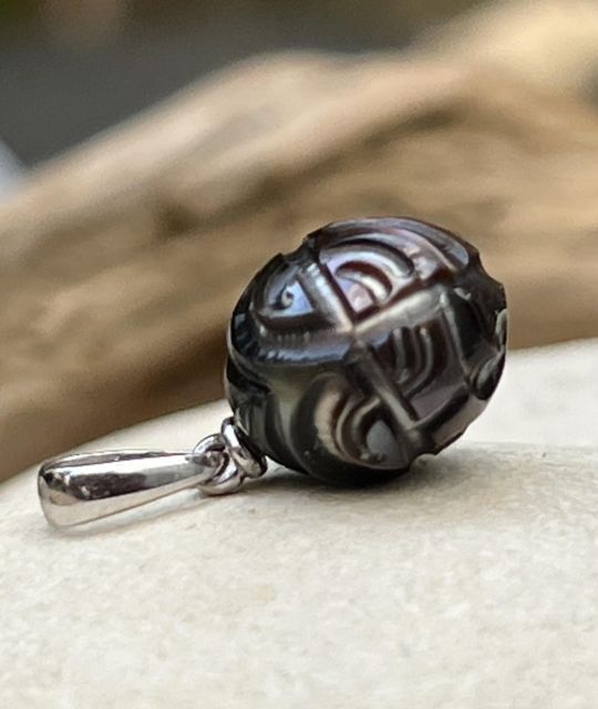 Magnifique perle noire de Tahiti avec une gravure marquisienne montée sur un pendentif en argent dans notre atelier de Nantes - certificat GIA - livraison offerte