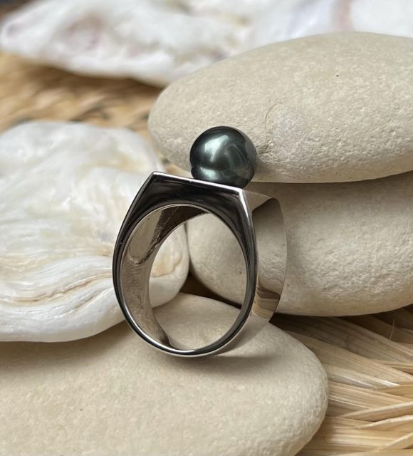 Découvrez notre chevalière en argent rhodié, ornée d'une véritable perle de culture de Tahiti d'un noir profond.