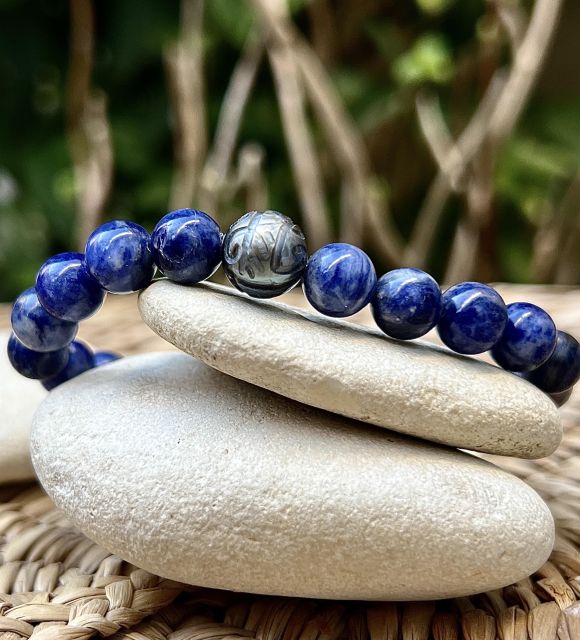 Au cœur du bracelet homme, une perle de Tahiti aux nuances grise et verte semble garder le secret des récifs, entre lumière changeante et puissance intérieure.