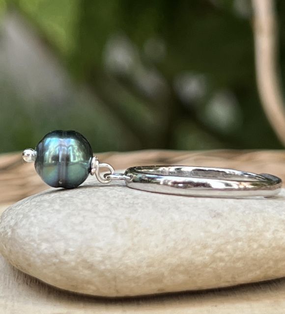 Découvrez Ori, une bague en argent rhodié réglable ornée d'une véritable Perle de Tahiti bleu violine de 7,74 mm. Une création unique aux reflets profonds et au lustre exceptionnel