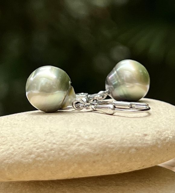 Découvrez Moana Pō, une paire unique de boucles d'oreilles pendantes en argent 925 rhodié, sublimée par deux véritables perles de Tahiti semi-baroques de 9,50 mm au vert lagon intense et au lustre exceptionnel. Photos contractuelles. Livraison soignée.