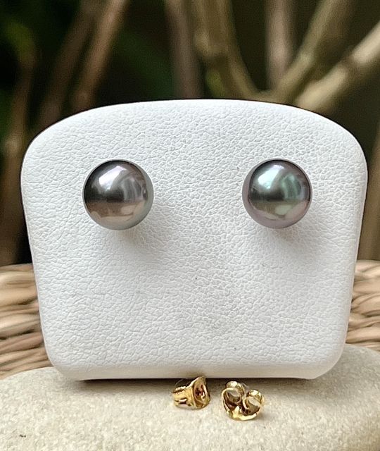 Die Ohrstecker Te Aho enthüllen den subtilen Glanz von zwei runden Tahiti-Perlen mit einem Durchmesser von 8,78 mm, die seltene blau-rosa Schimmer und einen ausgezeichneten Glanz aufweisen.